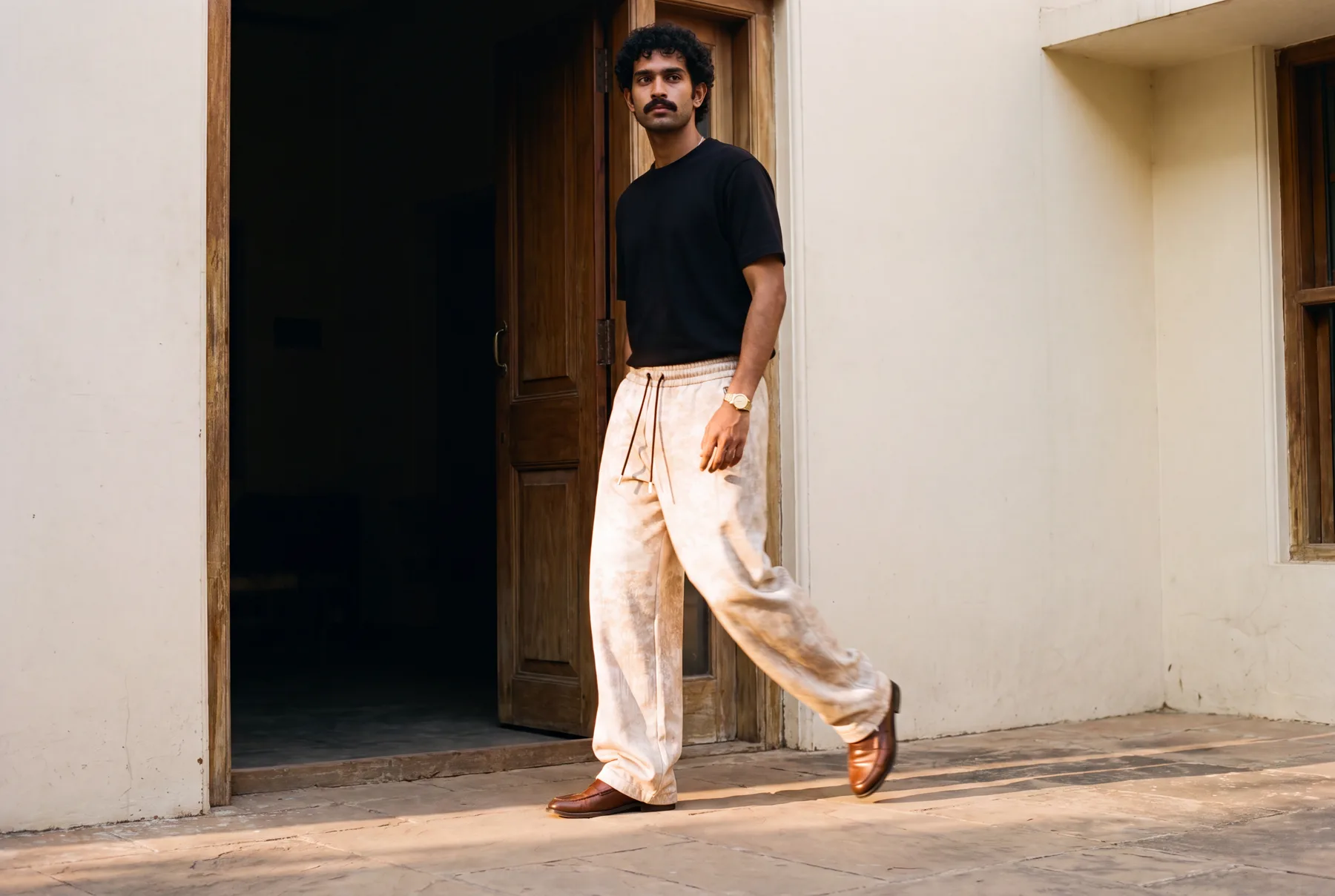 Desert Moss jogger campaign in a warm sculptural doorway